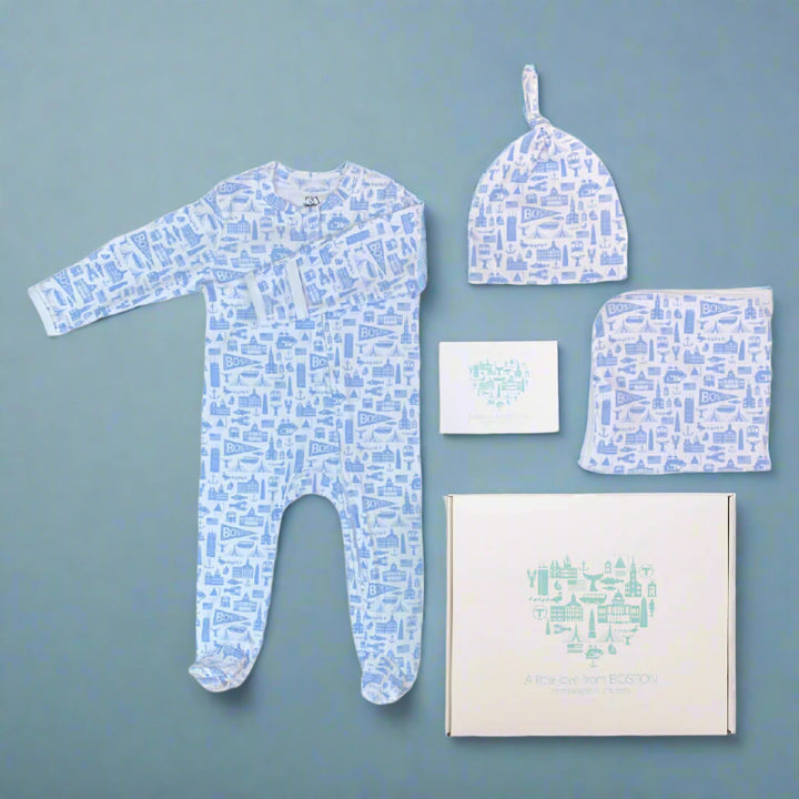 Soft cotton Boston themed blue and white baby apparel gift set which includes a zipper long sleeve onesie a knit baby hat and a baby blanket along with a gift box and note card