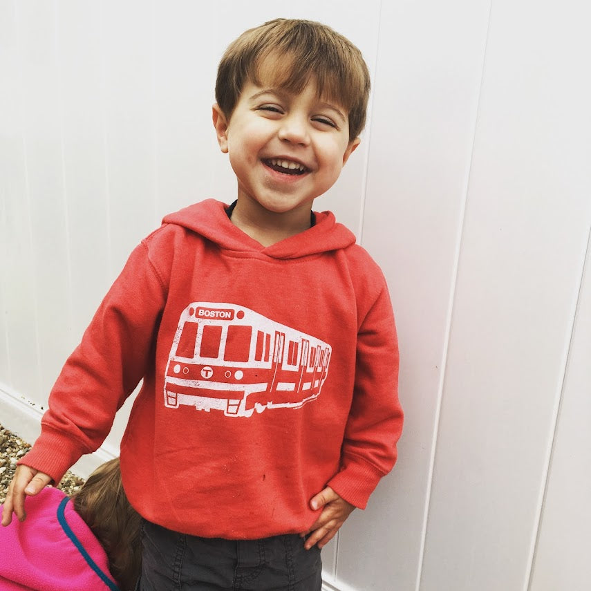 boy wearing red boston mbta red line train hoodie